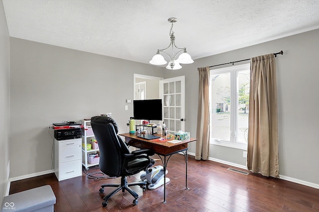 home office with visible vents, baseboards, a notable chandelier, and dark wood finished floors