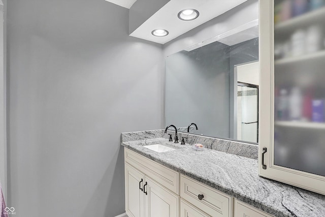 bathroom featuring recessed lighting and vanity