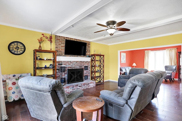 living area featuring a brick fireplace, crown molding, dark wood finished floors, beamed ceiling, and a ceiling fan