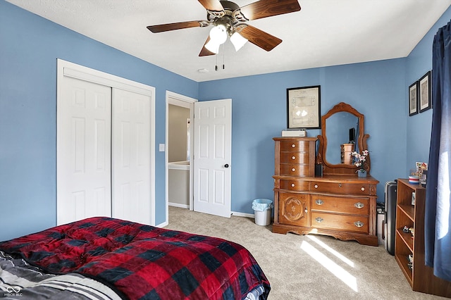 bedroom with a closet, carpet floors, baseboards, and ceiling fan