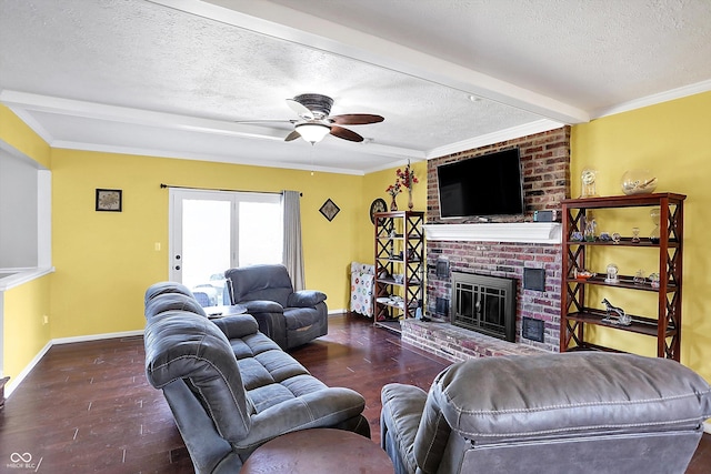 living area with a ceiling fan, a textured ceiling, wood finished floors, baseboards, and a brick fireplace