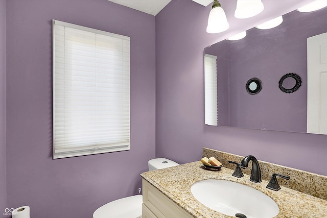 bathroom featuring toilet and vanity