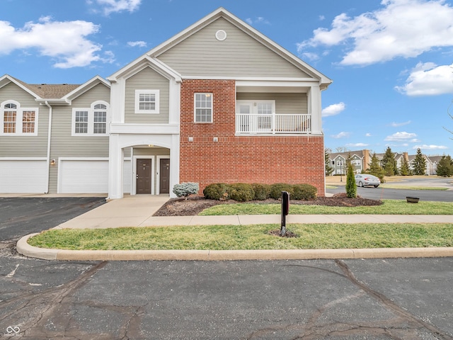 view of front of house with brick siding, driveway, and an attached garage