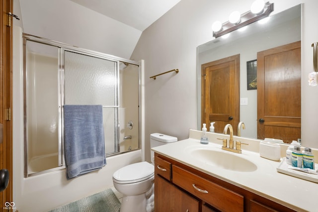 full bathroom featuring combined bath / shower with glass door, toilet, vanity, and vaulted ceiling