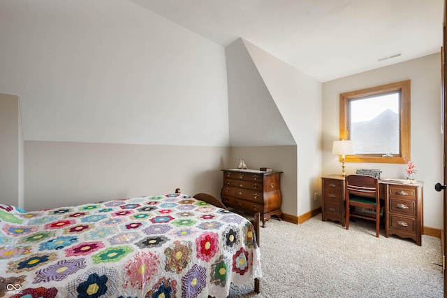 bedroom featuring visible vents, baseboards, light colored carpet, and vaulted ceiling