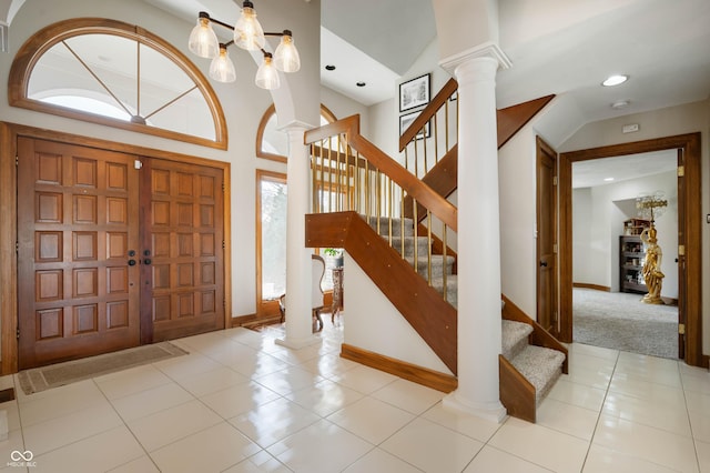 foyer with recessed lighting, stairway, tile patterned flooring, baseboards, and ornate columns