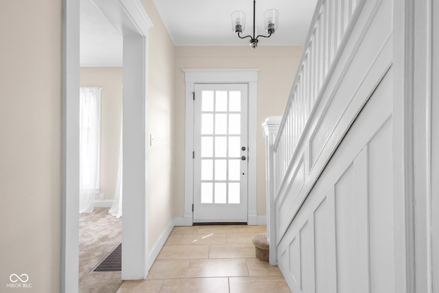 doorway with light tile patterned floors, visible vents, plenty of natural light, and stairs