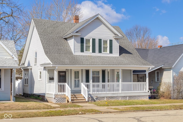 view of front of property featuring a porch, a chimney, a front lawn, and a shingled roof