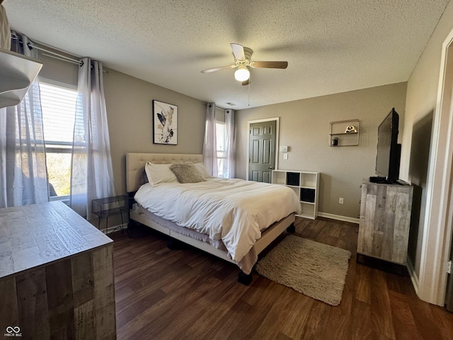 bedroom featuring baseboards, a textured ceiling, ceiling fan, and wood finished floors