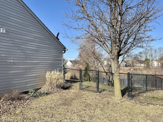 view of yard with fence and a gate