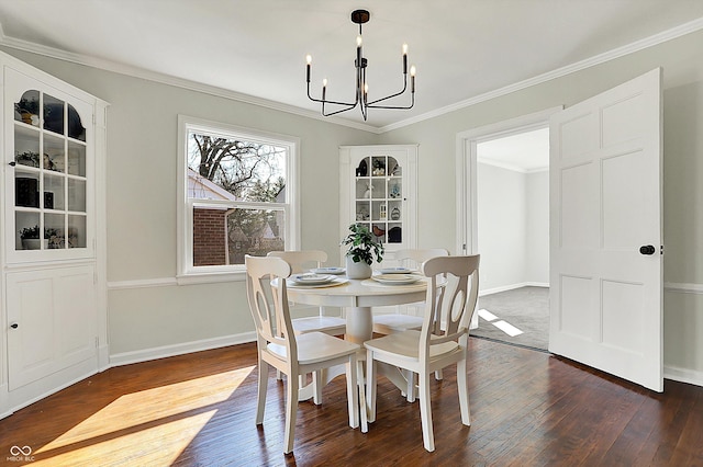 dining room with baseboards, an inviting chandelier, dark wood-style flooring, and crown molding