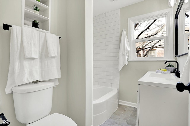 bathroom with baseboards, toilet, vanity, and tile patterned flooring