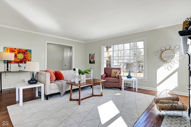 living room with baseboards, wood finished floors, and crown molding