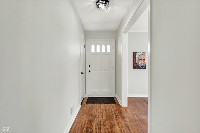 doorway to outside with visible vents, baseboards, and dark wood-style floors