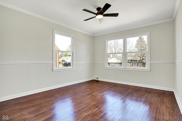 unfurnished room with a ceiling fan, baseboards, visible vents, hardwood / wood-style flooring, and crown molding