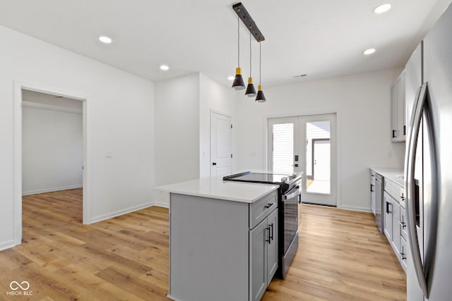 kitchen featuring recessed lighting, french doors, appliances with stainless steel finishes, and light wood finished floors