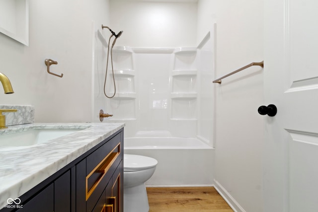 bathroom with shower / tub combination, wood finished floors, vanity, and toilet