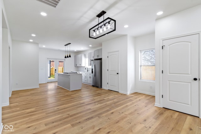 kitchen with visible vents, light wood-style flooring, recessed lighting, stainless steel fridge with ice dispenser, and a sink