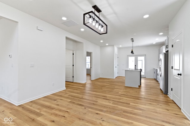 kitchen featuring light wood finished floors, recessed lighting, and freestanding refrigerator