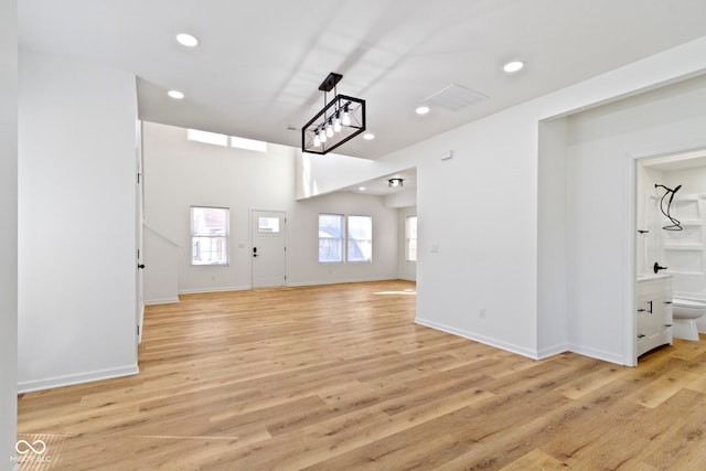 interior space with recessed lighting, light wood-style flooring, and baseboards