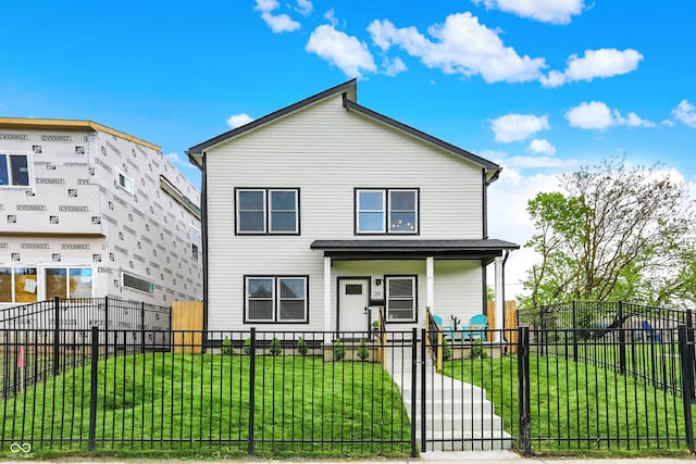 35 N Keystone Ave, Indianapolis, IN 46201 - view of front facade featuring a front yard, a fenced front yard, covered porch, and a gate
