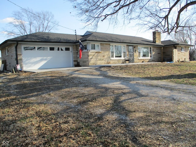 ranch-style house with stone siding, dirt driveway, an attached garage, and a chimney