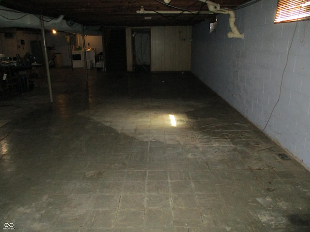 basement with tile patterned floors and washer / clothes dryer