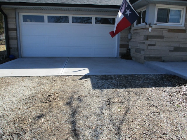 garage with concrete driveway