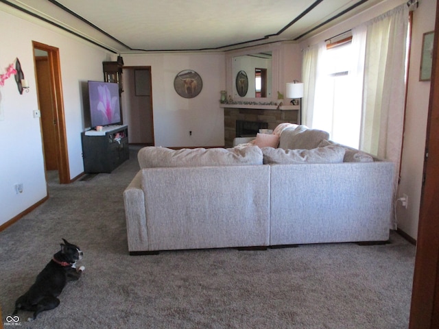 living room featuring a fireplace, carpet, and baseboards