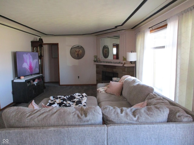 living room featuring a wealth of natural light, a fireplace, and carpet floors