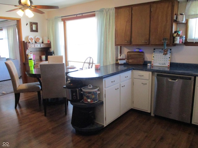 kitchen featuring dark wood-style floors, a ceiling fan, a peninsula, white cabinets, and stainless steel dishwasher