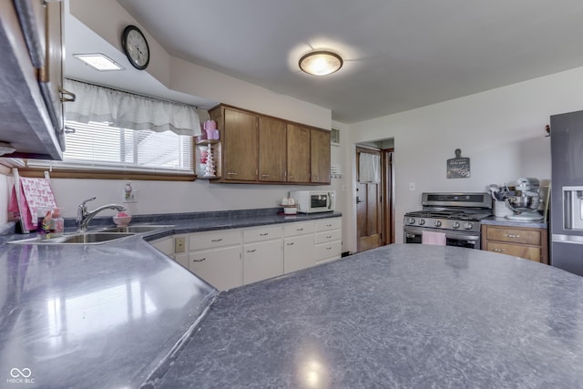 1459 S Josephine St, Martinsville, IN 46151 - kitchen with stainless steel gas range, white microwave, a sink, stainless steel counters, and white cabinets