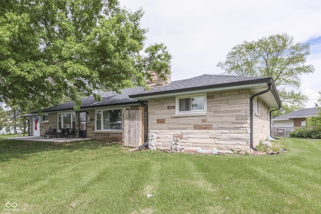 1459 S Josephine St, Martinsville, IN 46151 - back of house featuring stone siding, a chimney, a patio area, and a lawn