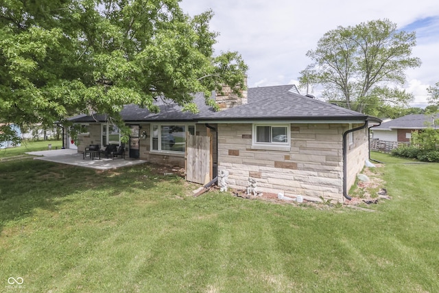 1459 S Josephine St, Martinsville, IN 46151 - rear view of property featuring stone siding, a shingled roof, a patio area, a lawn, and a chimney