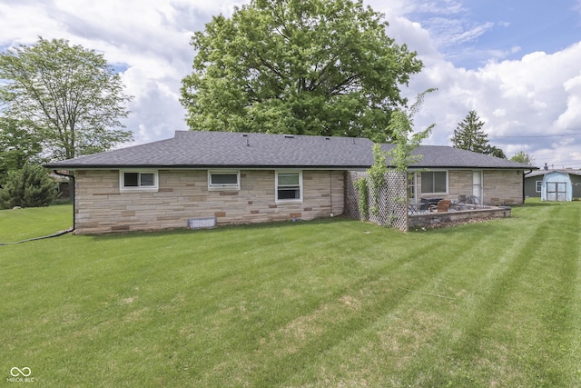 1459 S Josephine St, Martinsville, IN 46151 - rear view of house featuring stone siding, a yard, a shingled roof, and a storage unit