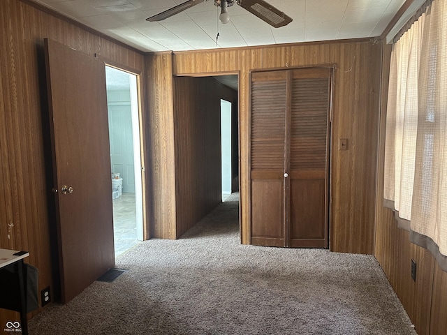 interior space with wood walls and carpet