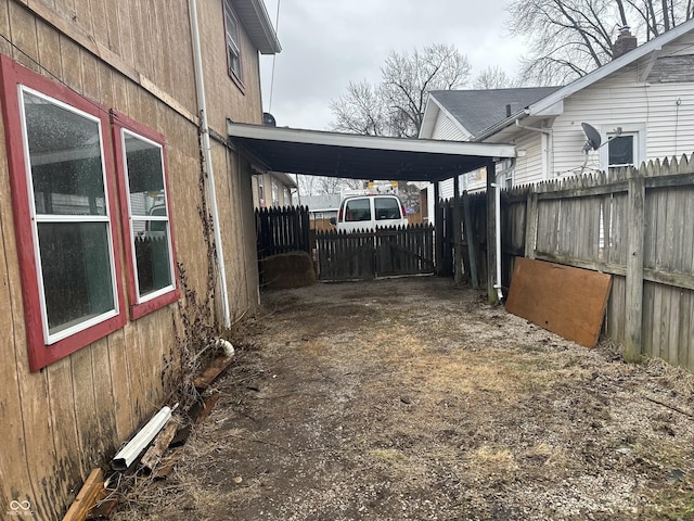 view of yard featuring a carport and fence