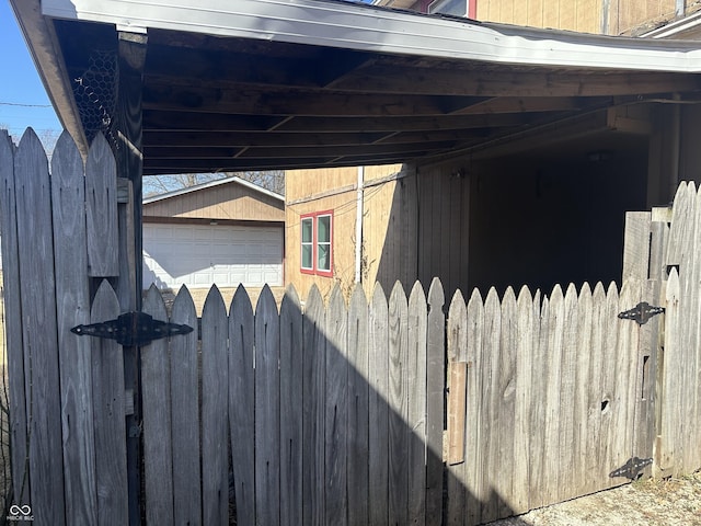 view of side of property featuring a carport and an outdoor structure