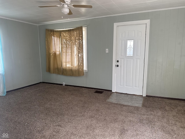 entrance foyer with baseboards, a ceiling fan, visible vents, and ornamental molding