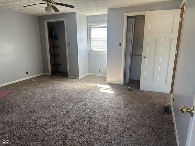 unfurnished bedroom featuring carpet, visible vents, and baseboards