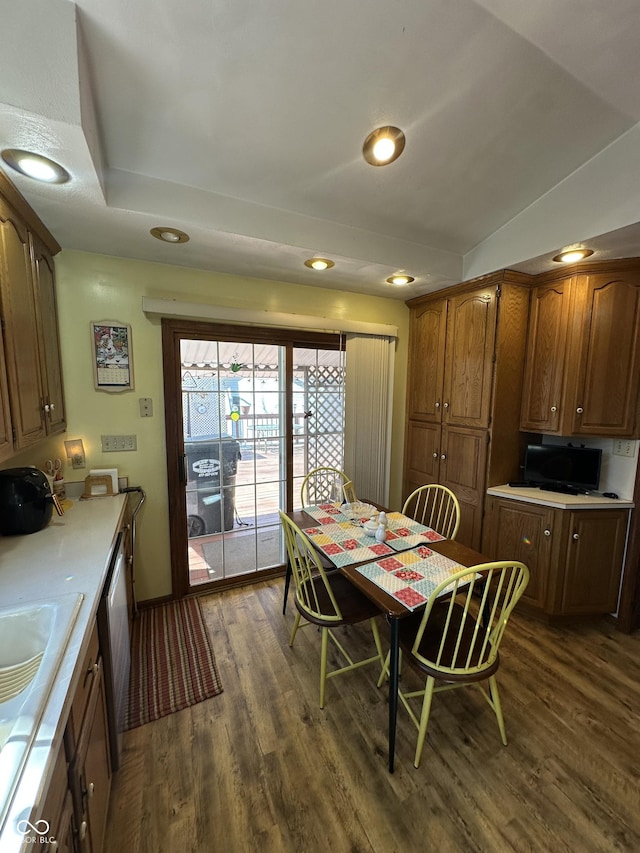 dining area featuring dark wood finished floors, vaulted ceiling, and recessed lighting