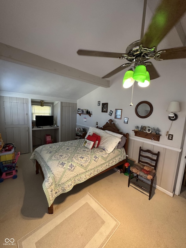 bedroom with carpet flooring, vaulted ceiling with beams, and a ceiling fan