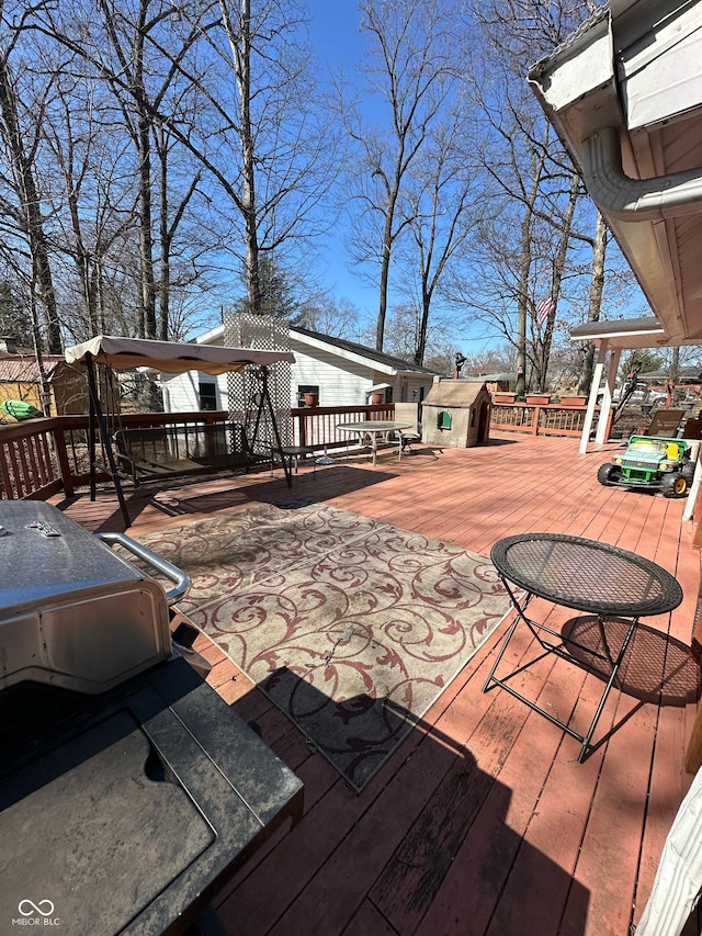 deck with an outbuilding and a storage unit