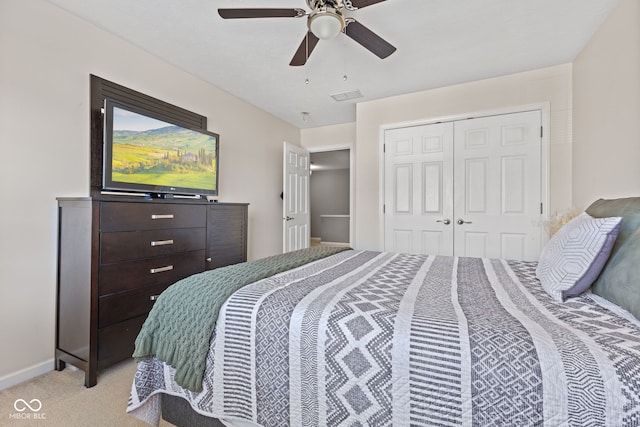 bedroom featuring a ceiling fan, baseboards, visible vents, a closet, and light carpet