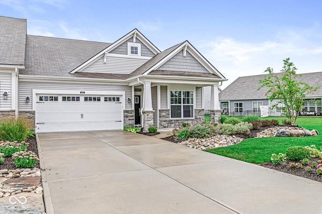 view of front of property featuring driveway and stone siding