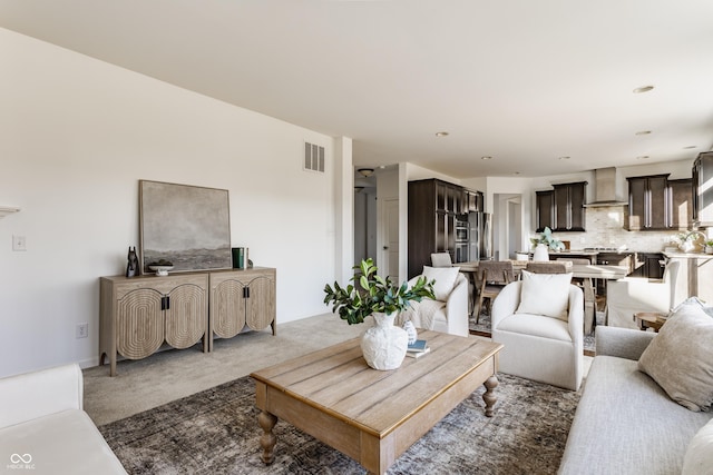 carpeted living room featuring visible vents