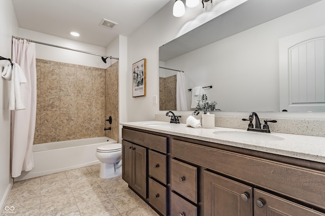 full bath with double vanity, visible vents, toilet, and a sink