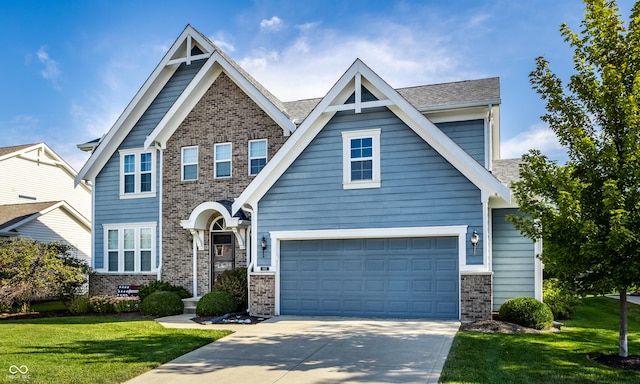 craftsman inspired home featuring brick siding, a garage, driveway, and a front yard