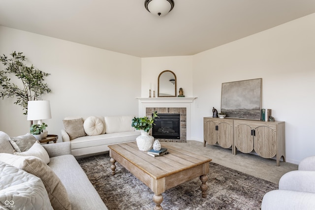 carpeted living room with baseboards and a tile fireplace