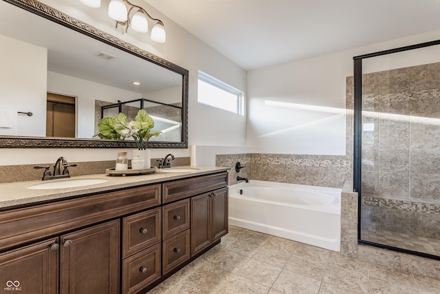 bathroom featuring a sink, a garden tub, double vanity, and a shower stall